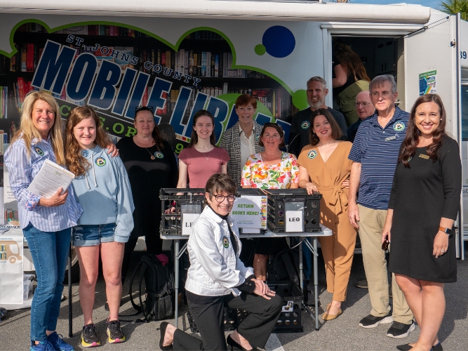 The Library Advisory Board team standing in front of the St. Johns County Public Library Bookmobile.