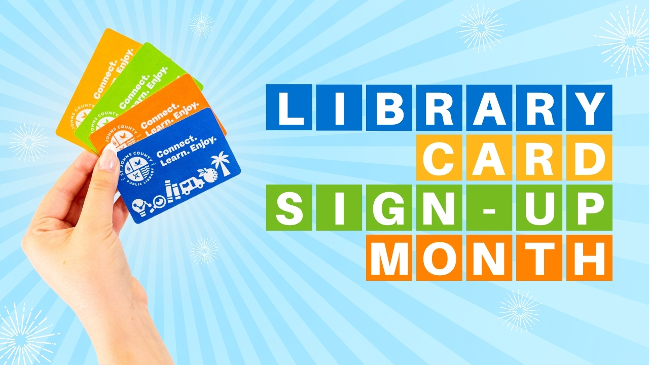 A hand holding four St. Johns County Public Library Cards. The text reads 